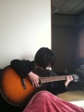 Aya, enjoying a soft guitar and a warm kotatsu.